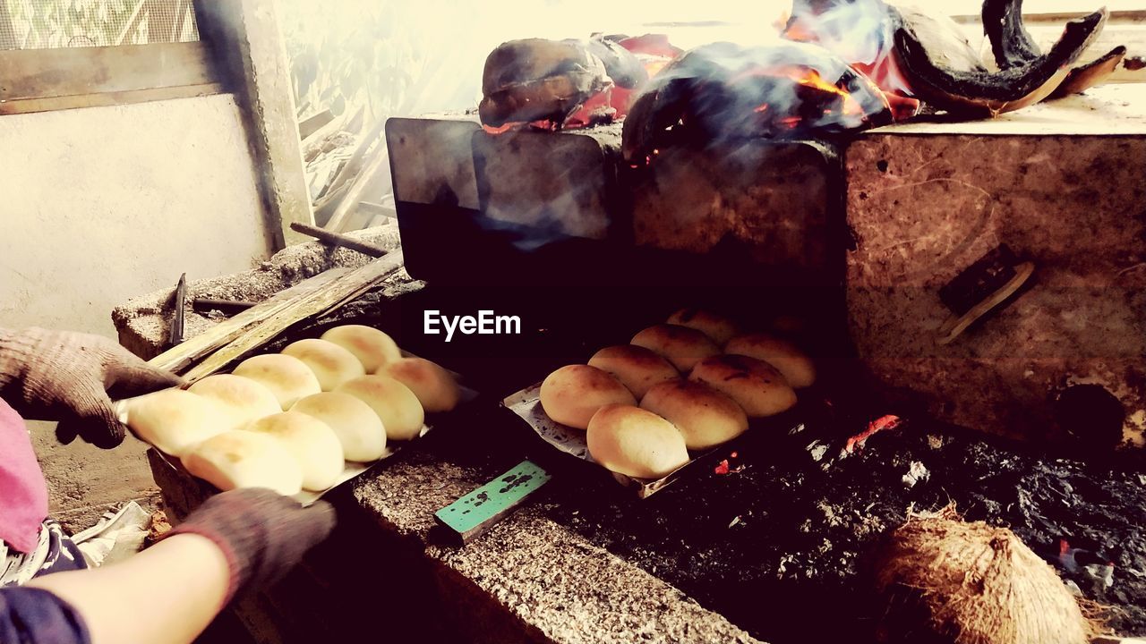 cropped hand of person preparing food on table