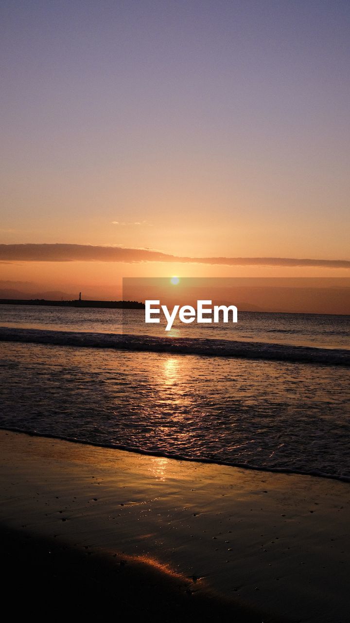 SCENIC VIEW OF SUNSET OVER SEA