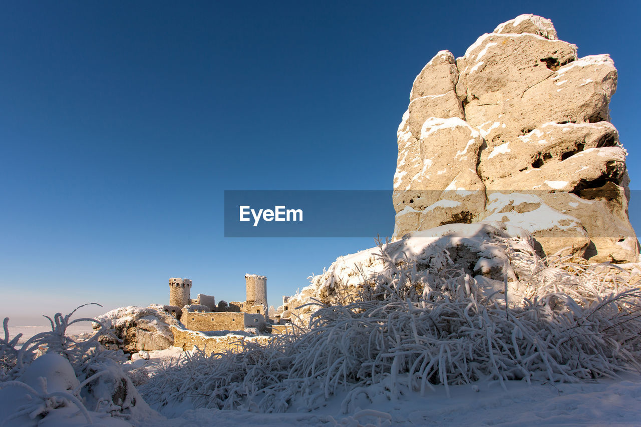 SNOW ON LAND AGAINST CLEAR BLUE SKY