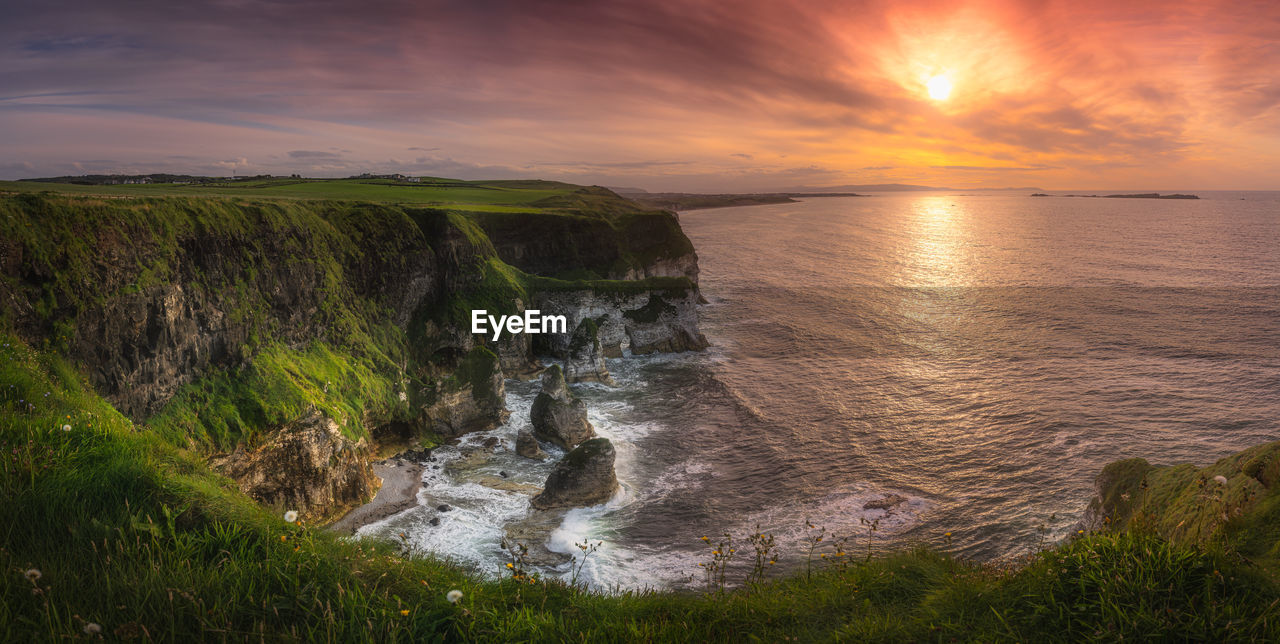 Wide panorama with beautiful white, limestone cliffs at dramatic sunset, northern ireland