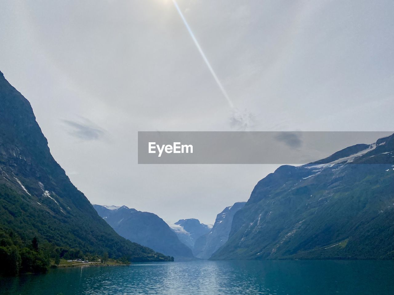 Scenic view of lake and mountains against sky