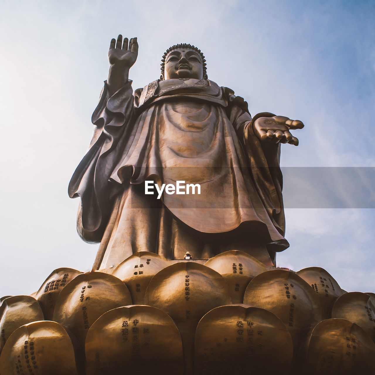 LOW ANGLE VIEW OF STATUE OF BUDDHA AGAINST SKY