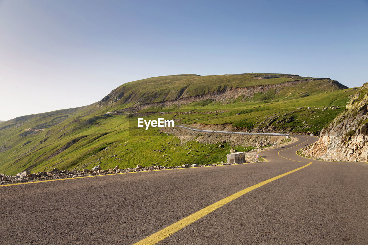 Scenic view of mountain road against clear sky