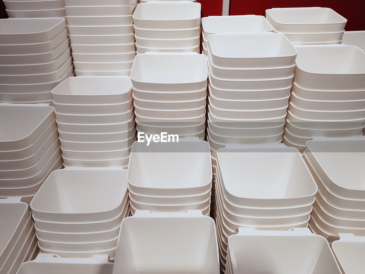 Full frame background of group of stacked white plastic containers