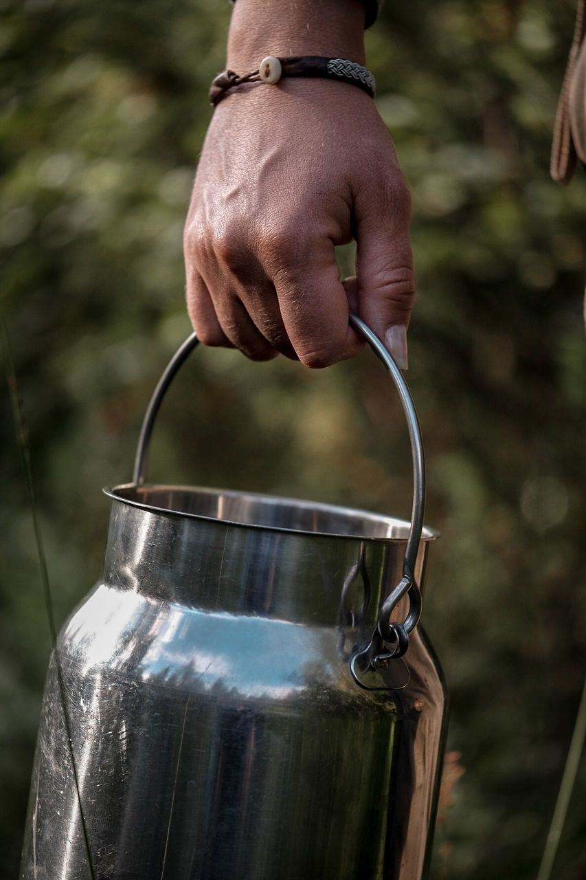 Close-up of hand holding container