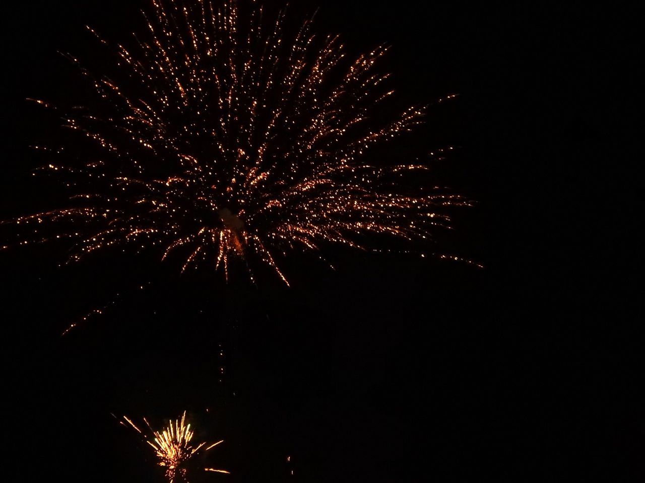 LOW ANGLE VIEW OF FIREWORKS DISPLAY