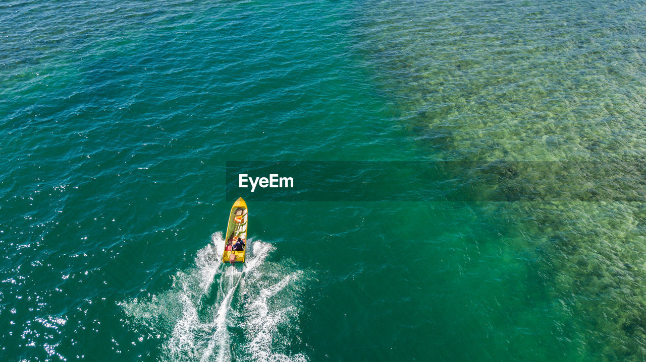 High angle view of man traveling in boat on sea