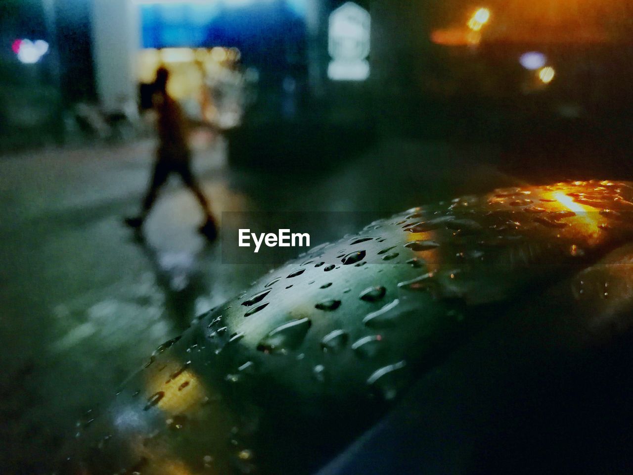 CLOSE-UP OF WET ILLUMINATED STREET IN CITY