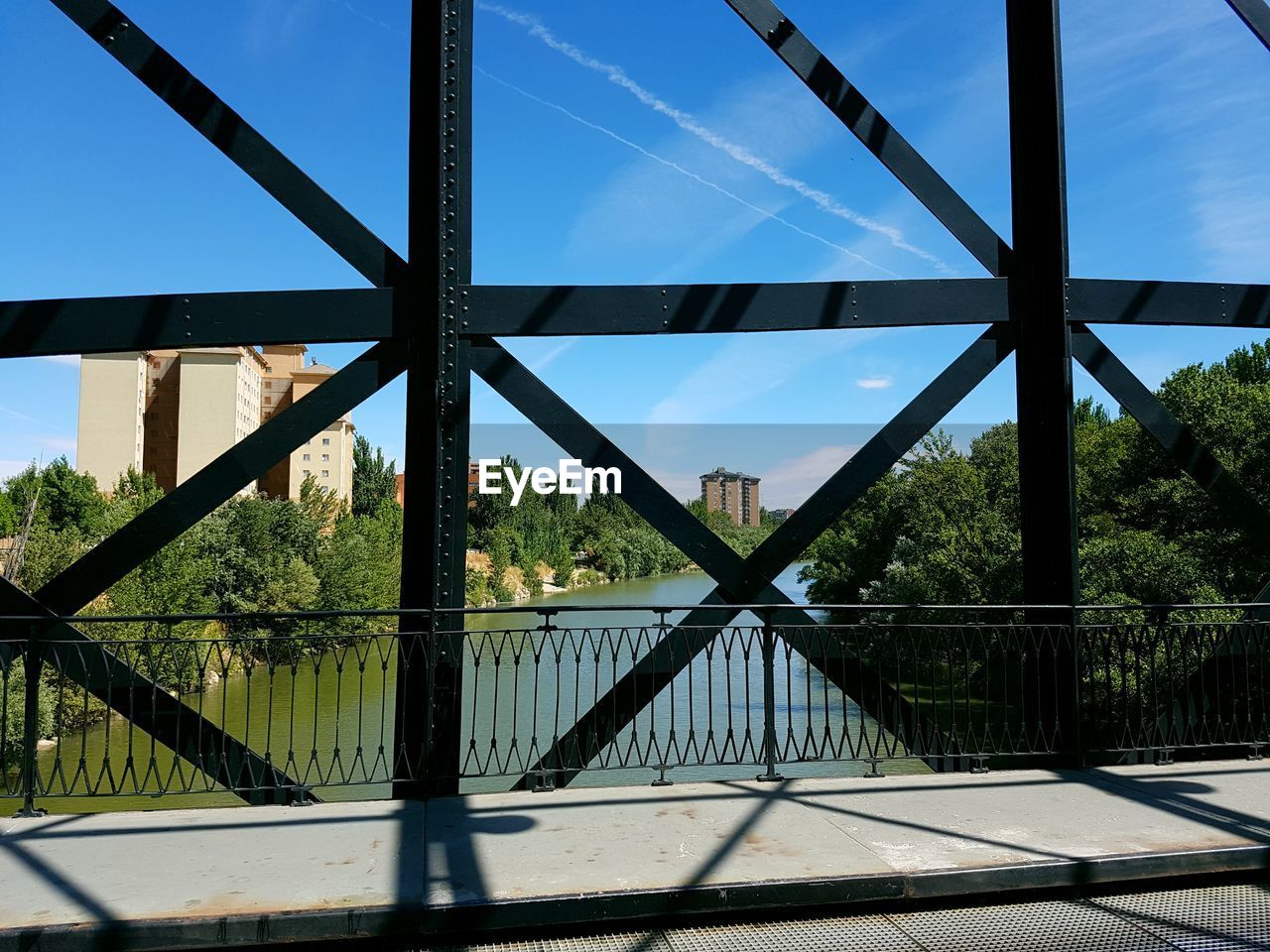 BRIDGE OVER TREES AGAINST SKY