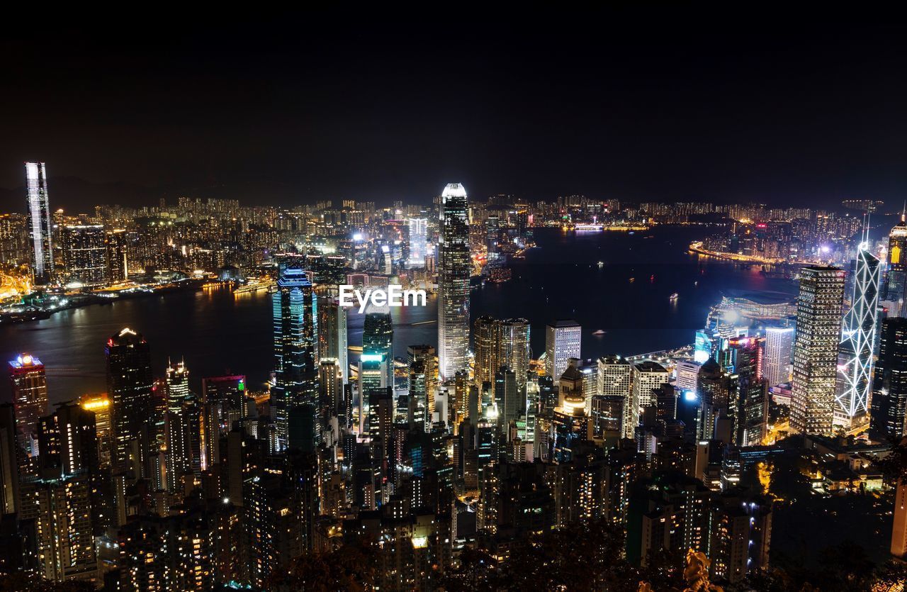 High angle view of city lit up at night