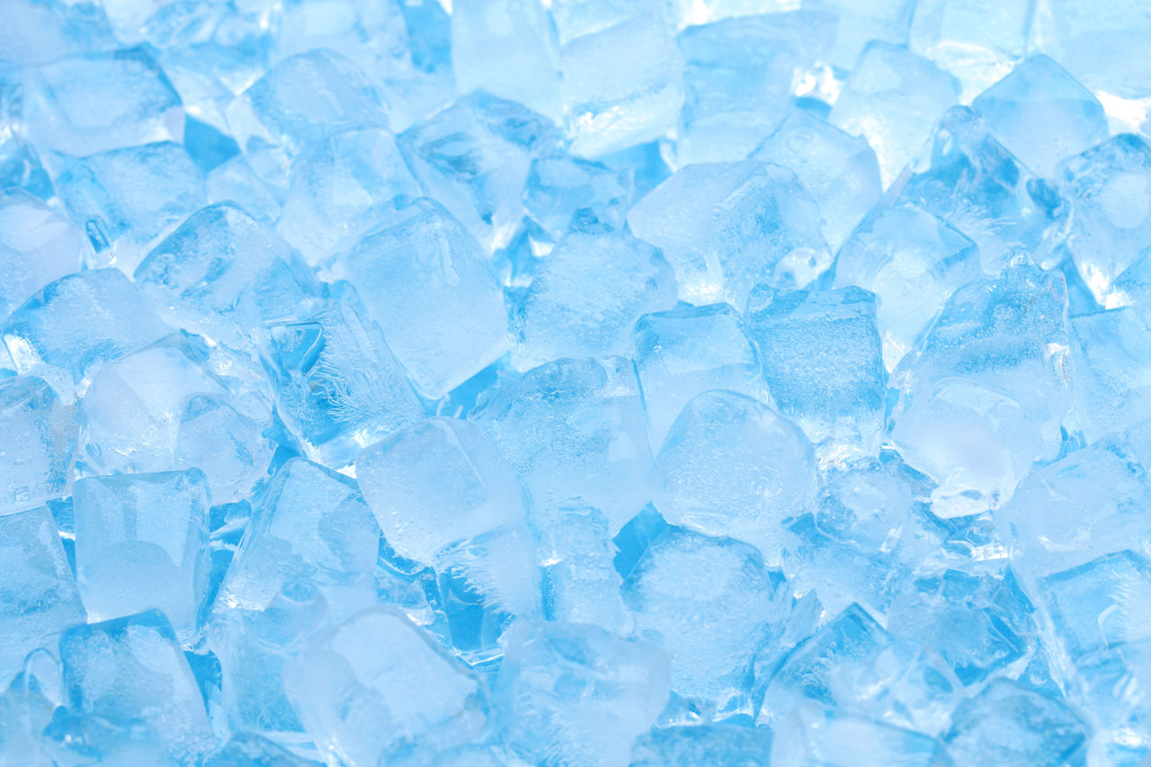 Winter clear blue ice cube texture or natural cold background