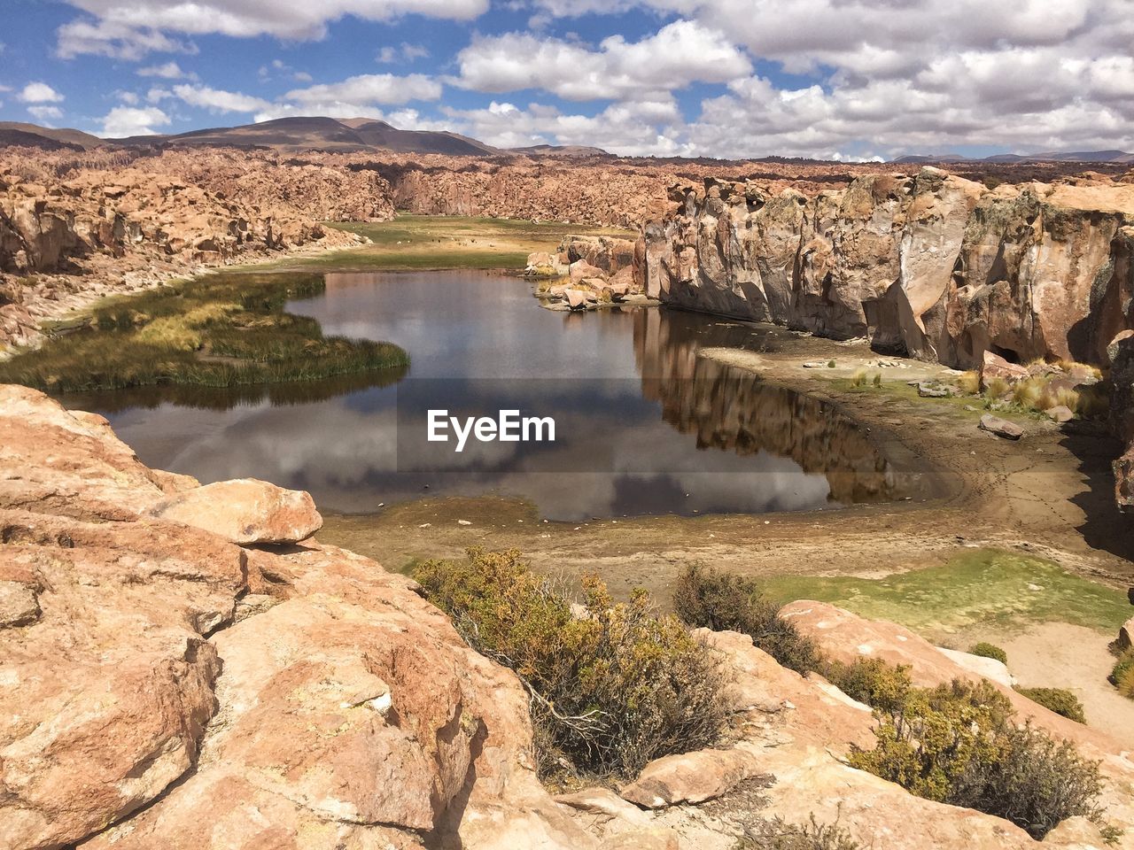 SCENIC VIEW OF ROCK FORMATIONS IN WATER AGAINST SKY