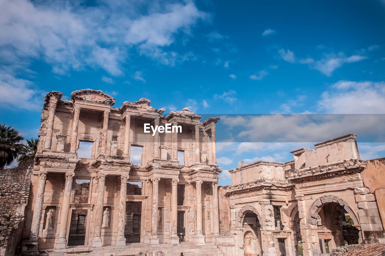 Low angle view of historical building against cloudy sky