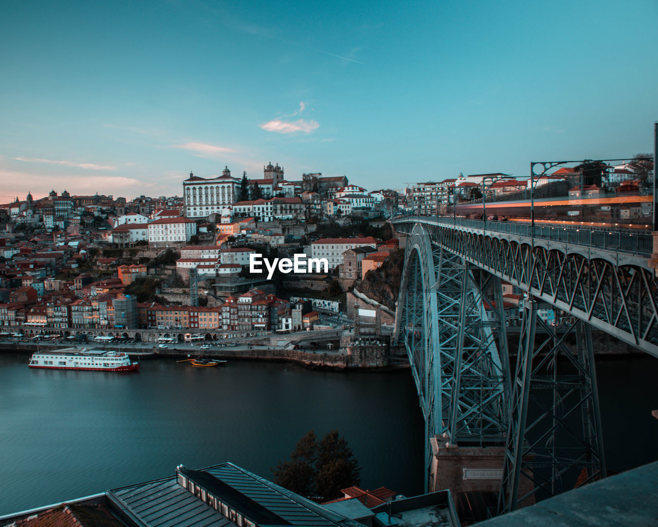 High angle view of bridge over river amidst buildings in city