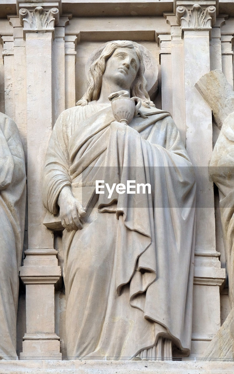 Saint john the apostle, statue on the facade of saint augustine church in paris, france