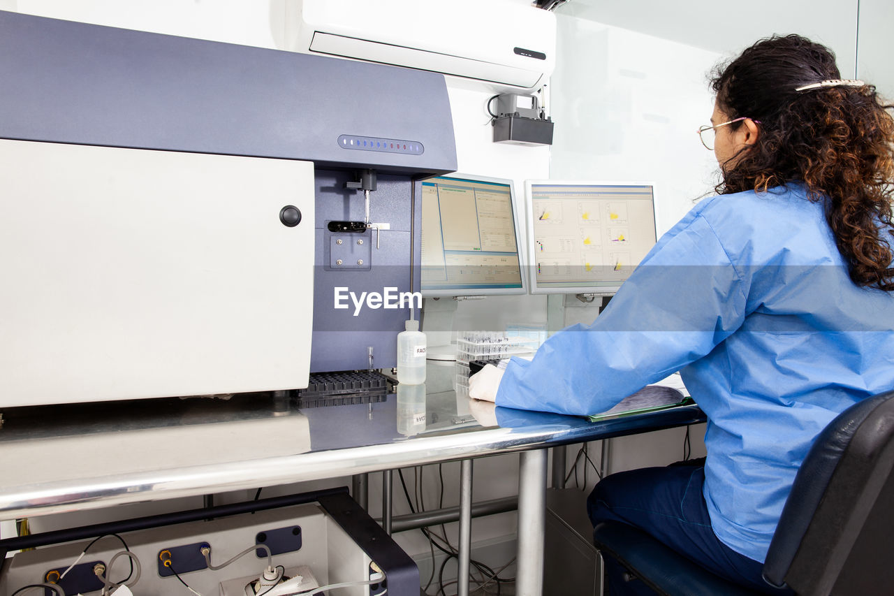 Scientist performing a flow cytometric analysis in the laboratory. flow cytometer.