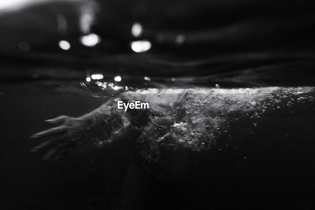 Girl hand underwater photo with slow shutter