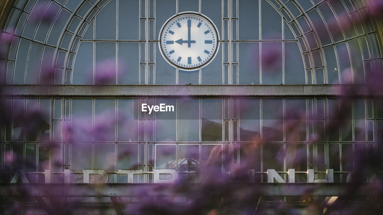 Low angle view of clock on glass window