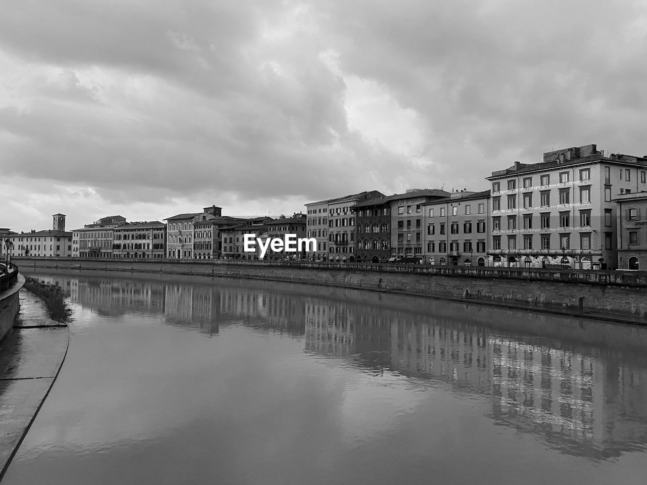 River by buildings against sky in city