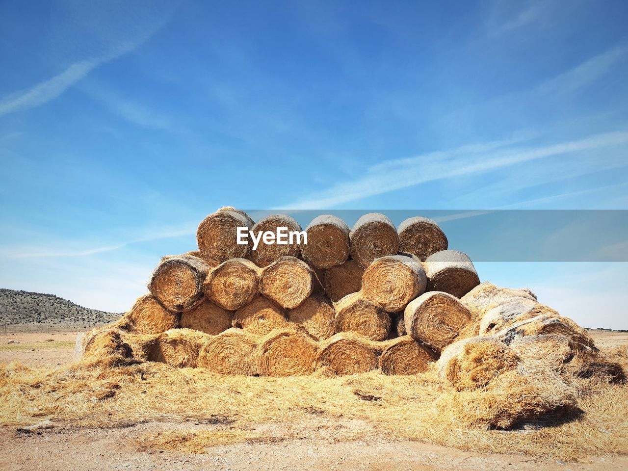 Stack of rocks on field against sky