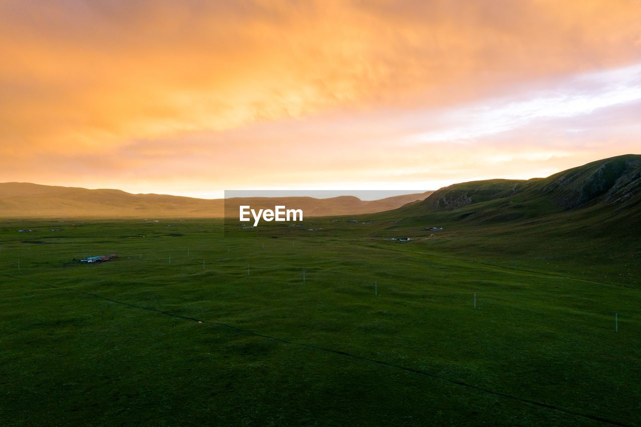 SCENIC VIEW OF FIELD AGAINST SKY DURING SUNSET