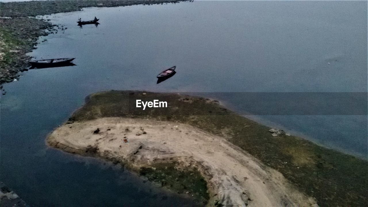 BIRD FLYING ABOVE LAKE