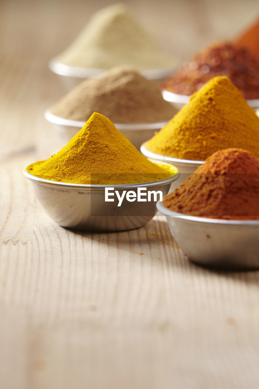 Close-up of various spices in containers on table