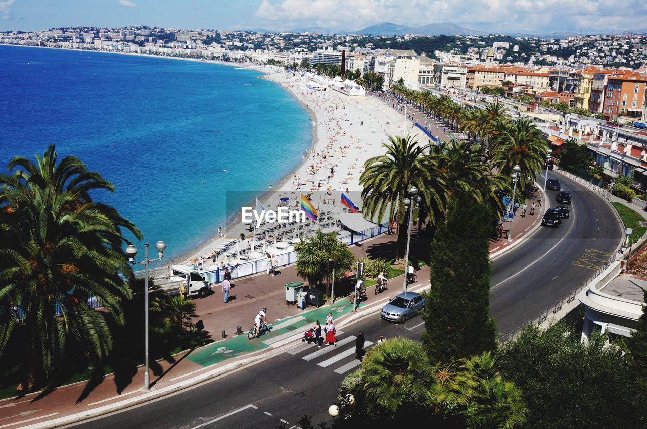 View of cityscape by road with vehicles and beach