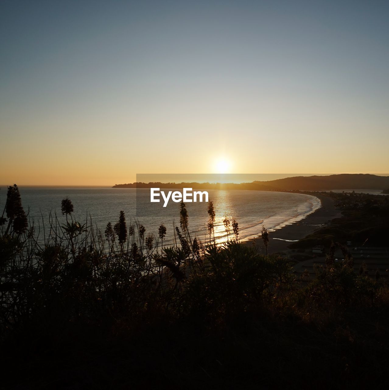 Scenic view of sea against clear sky during sunset