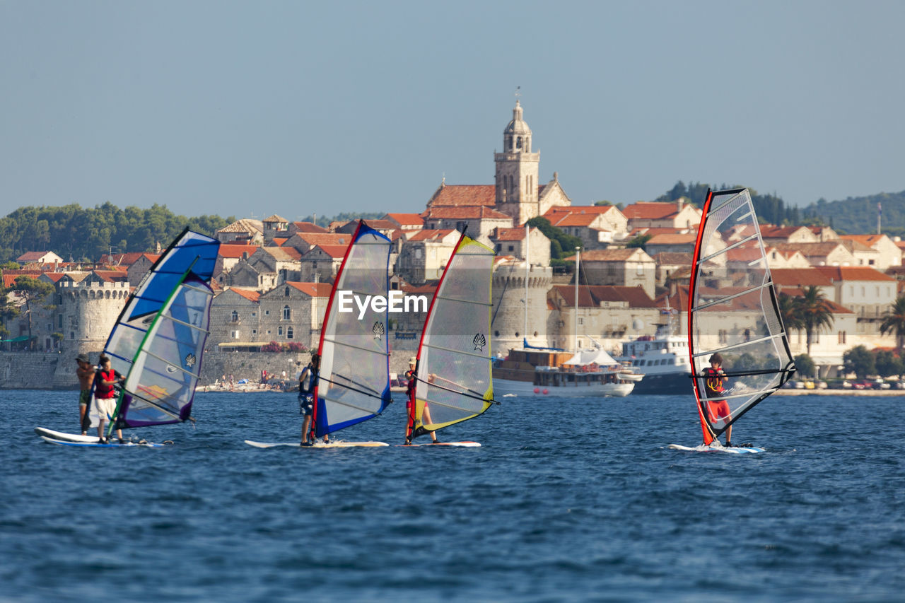 PEOPLE ON SEA AGAINST SKY