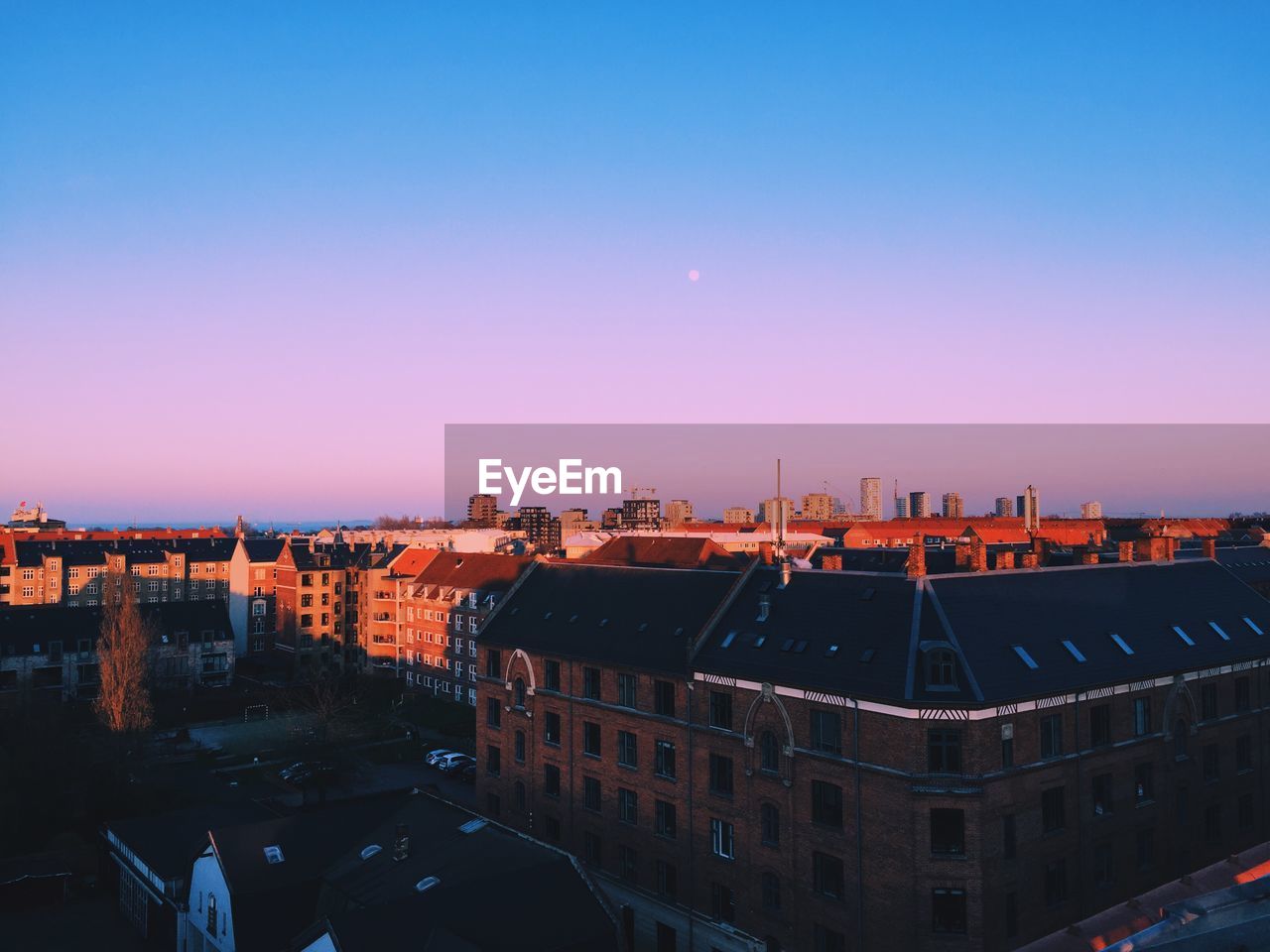 High angle view of buildings against clear sky during sunset