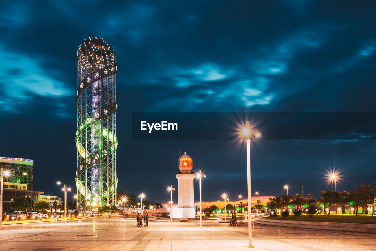 low angle view of illuminated buildings against sky at night