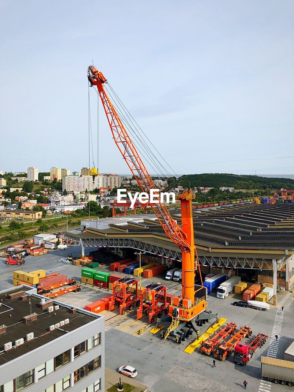 HIGH ANGLE VIEW OF CRANES AT CONSTRUCTION SITE
