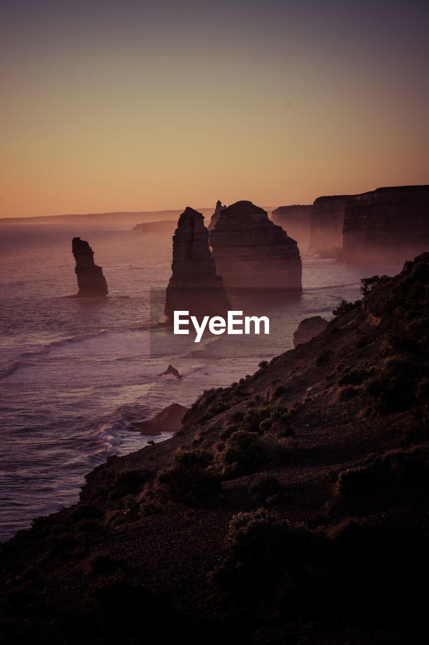 SCENIC VIEW OF ROCKS IN SEA AGAINST SKY