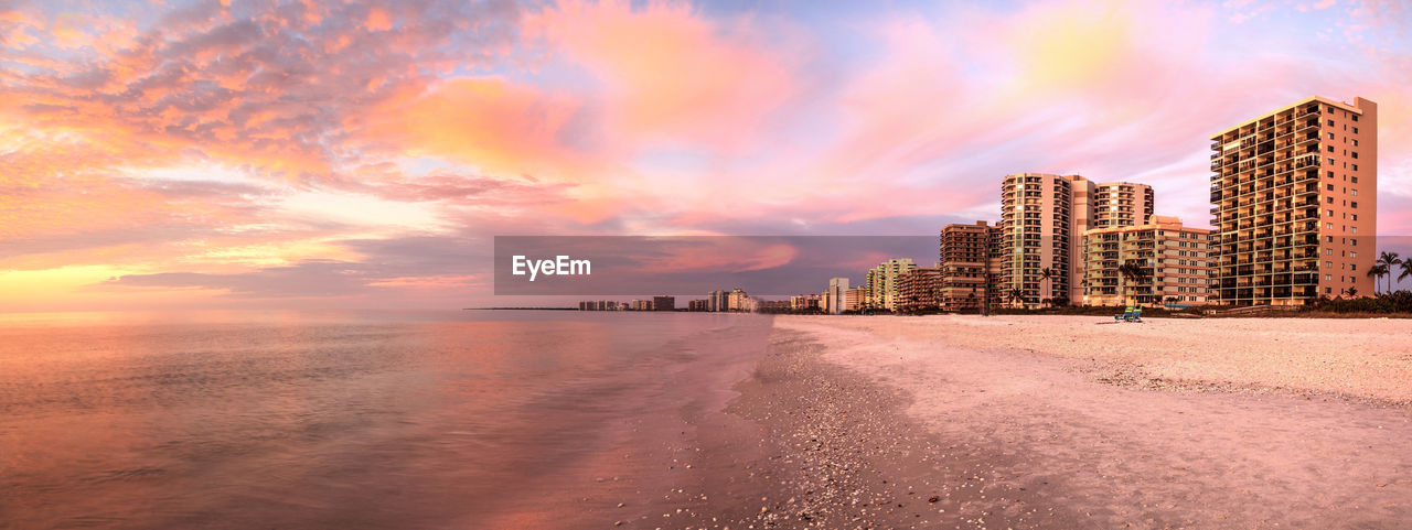 Scenic view of beach against sky during sunset