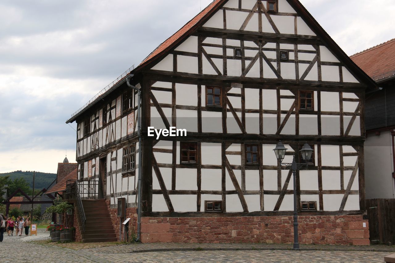 View of house against cloudy sky