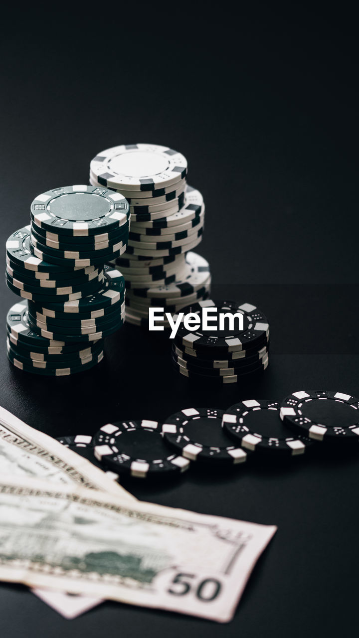 close-up of coins on table against black background