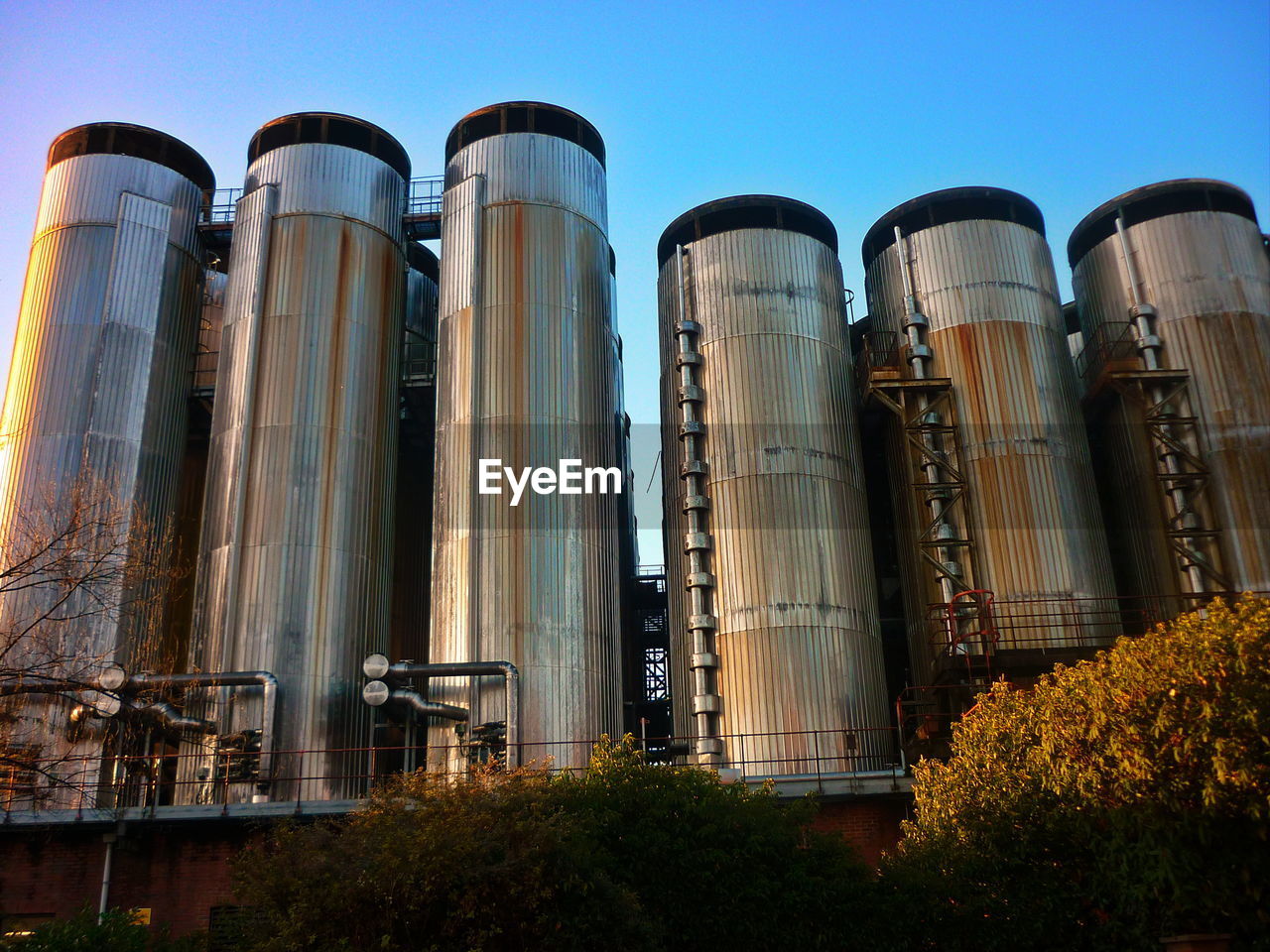 LOW ANGLE VIEW OF FACTORY AGAINST SKY