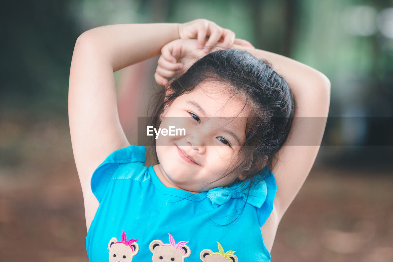 Close-up portrait of smiling cute innocent girl
