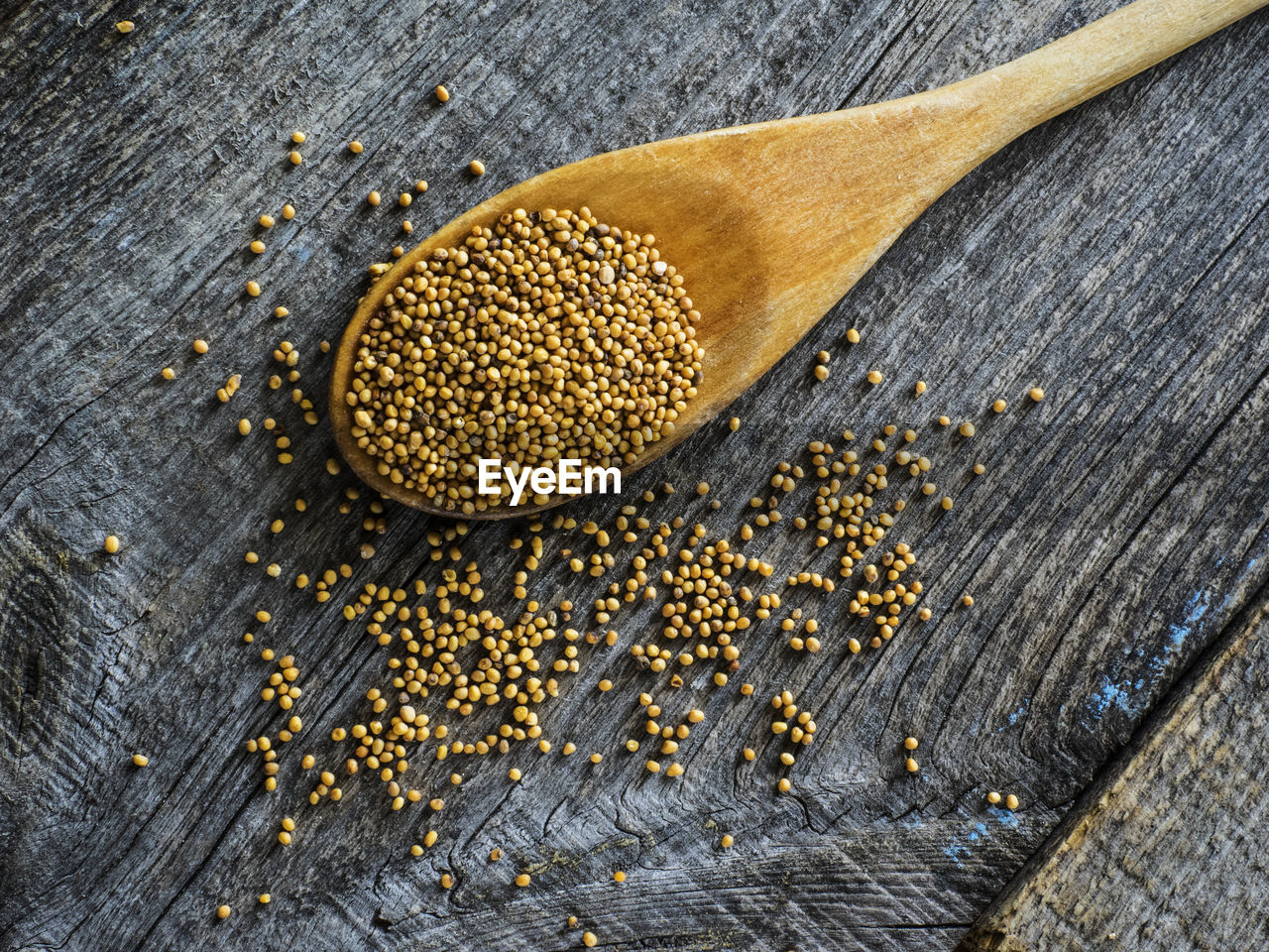 Close-up of mustard seeds in spoon on table