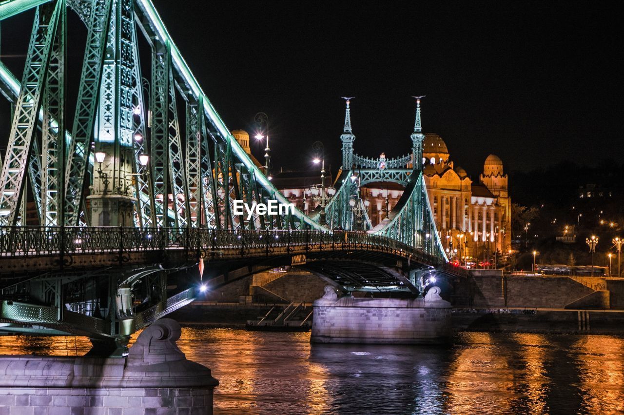 ILLUMINATED BRIDGE OVER RIVER