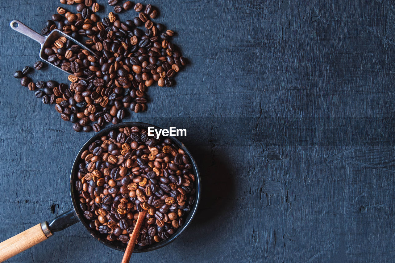 food and drink, food, freshness, directly above, wood, indoors, studio shot, kitchen utensil, no people, brown, spice, healthy eating, high angle view, roasted coffee bean, still life, copy space, wellbeing, table, ingredient, produce, coffee, eating utensil, seed, sweet food, fruit