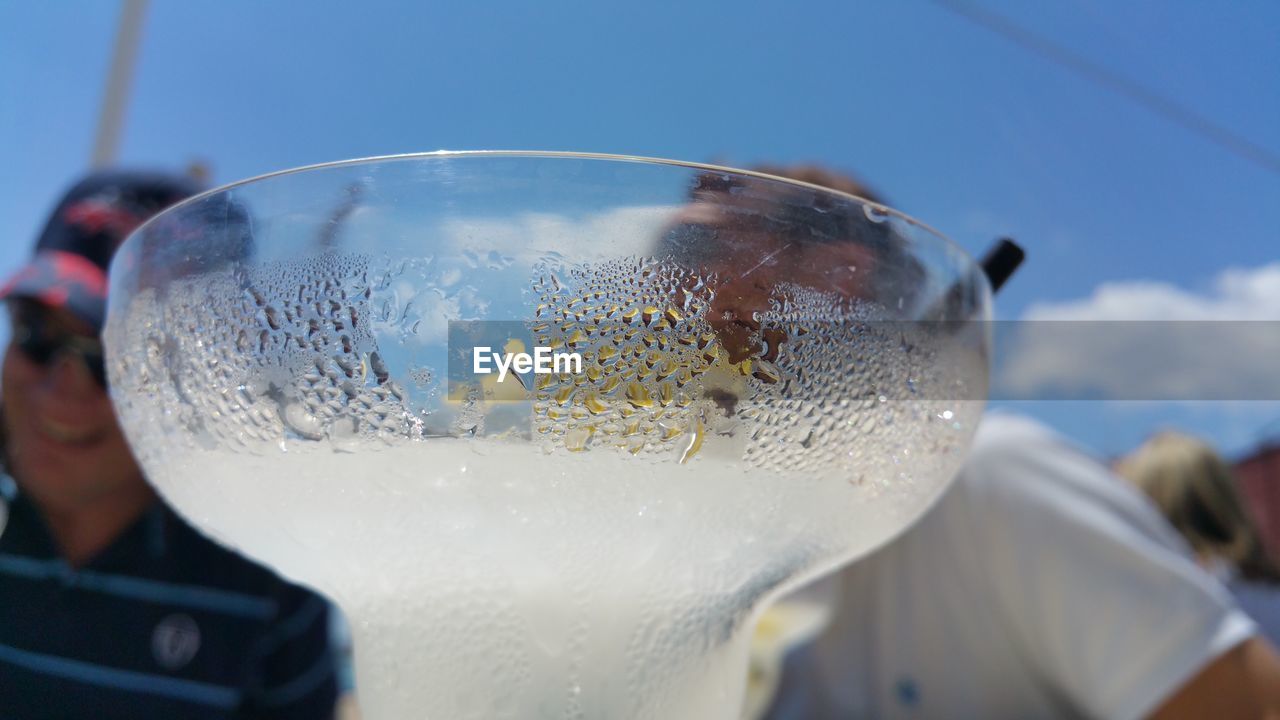 Close-up of condensed cocktail glass on sunny day