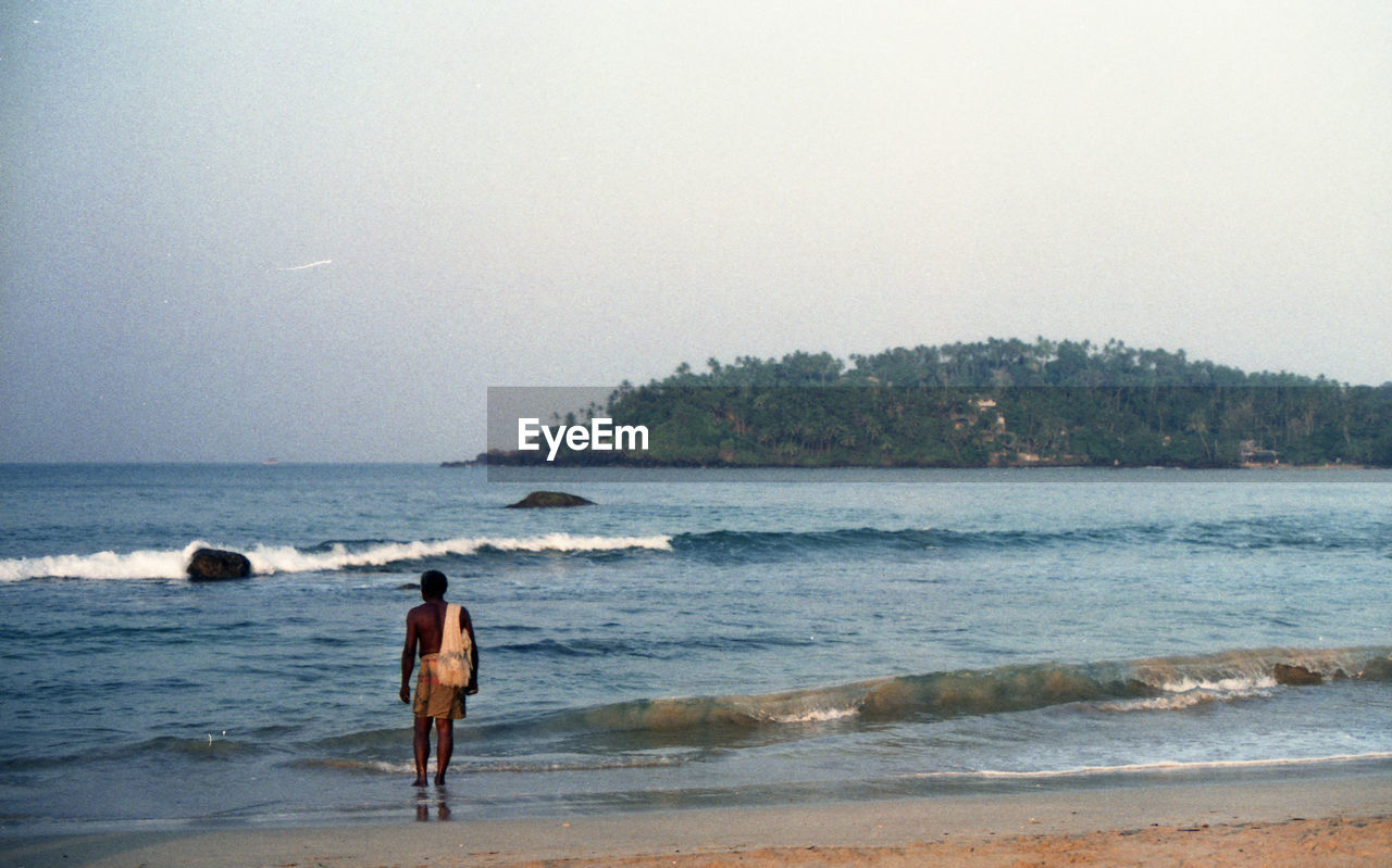 FULL LENGTH OF MAN ON BEACH