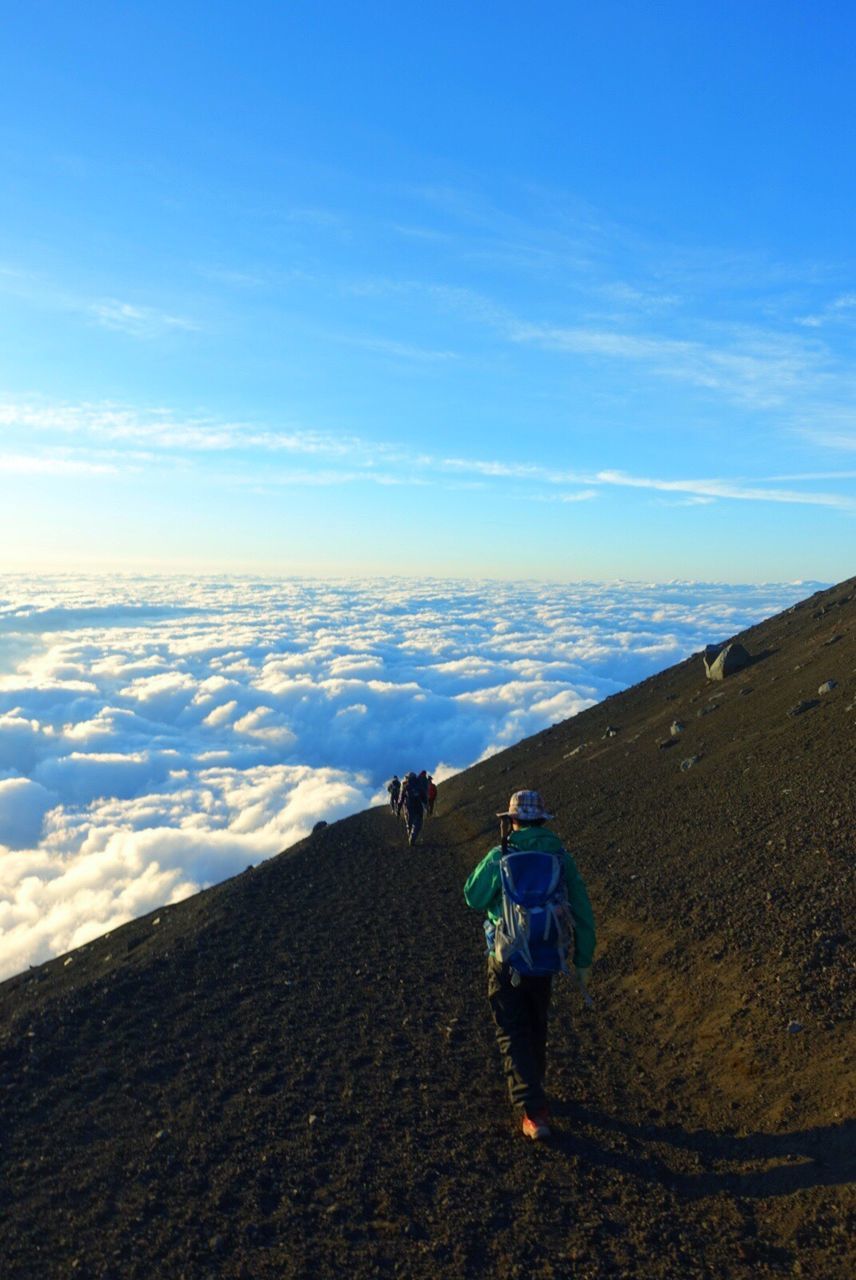 Rear view of backpacker hiking on mountain