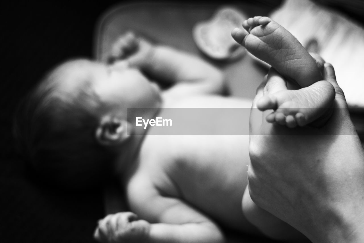 CLOSE-UP OF HANDS HOLDING BABY