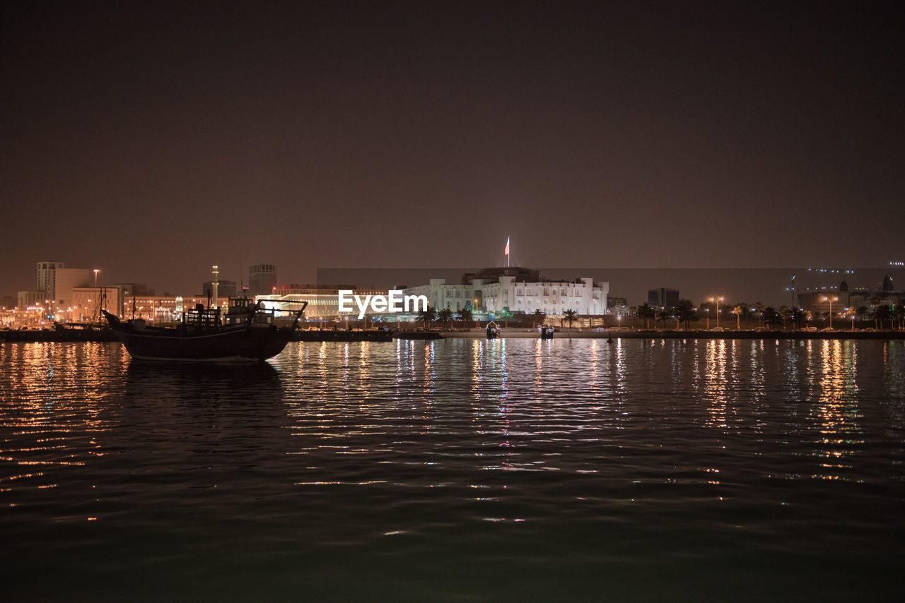 ILLUMINATED CITY AT WATERFRONT