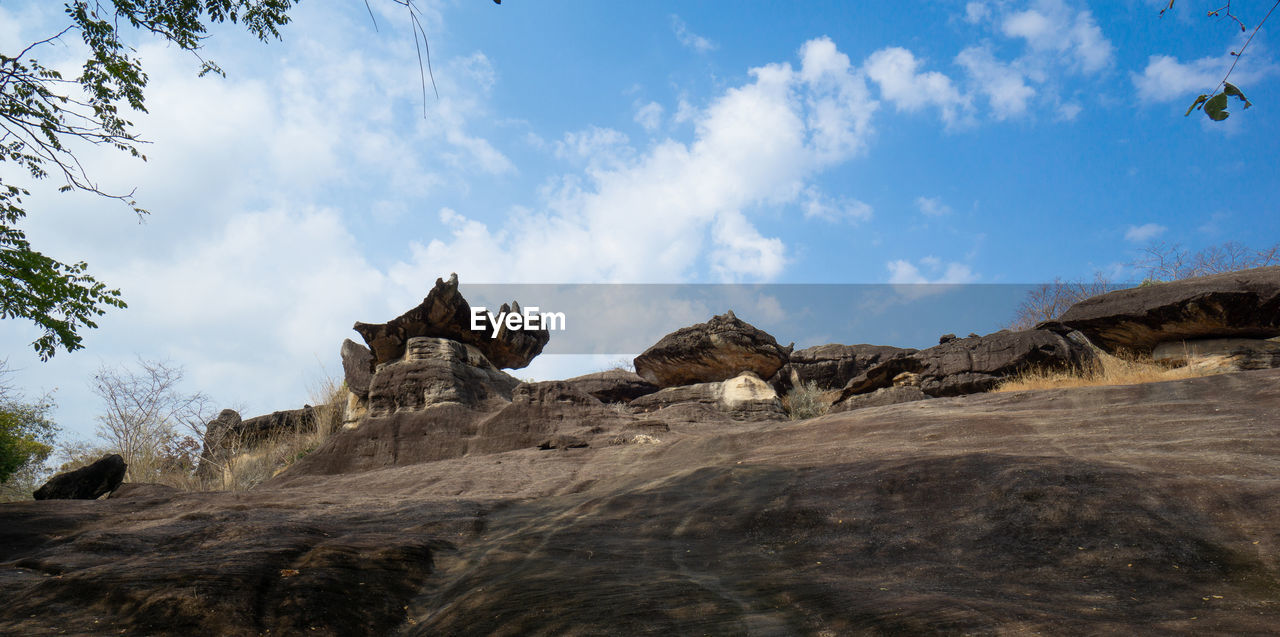 LOW ANGLE VIEW OF ROCK FORMATIONS ON LANDSCAPE AGAINST SKY