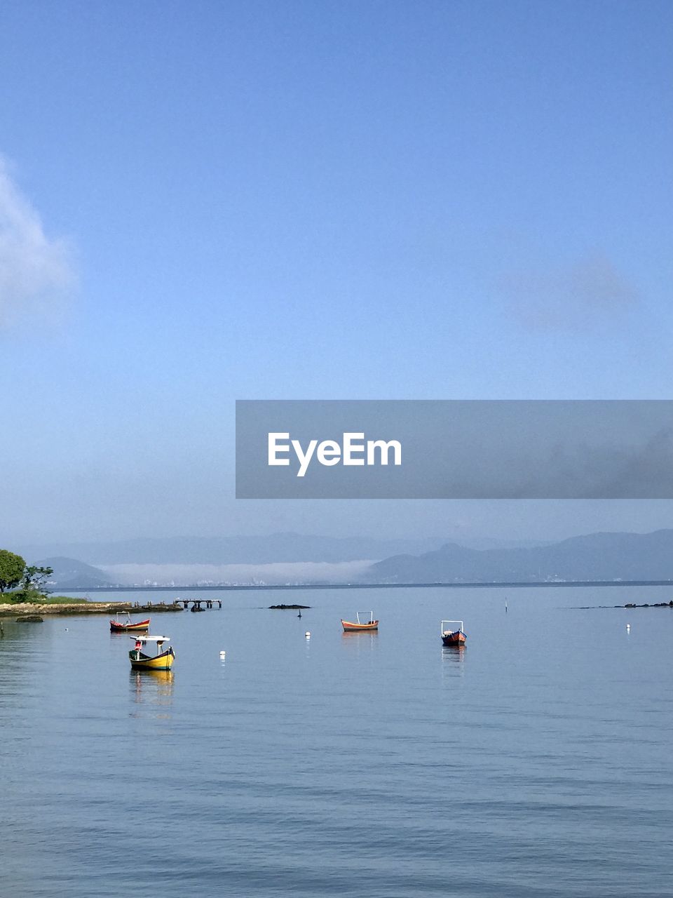 water, sky, nautical vessel, sea, transportation, nature, scenics - nature, beauty in nature, mode of transportation, tranquility, blue, vehicle, shore, tranquil scene, day, bay, no people, cloud, travel, horizon, outdoors, travel destinations, boating, boat, environment, non-urban scene, copy space, coast, land, idyllic, body of water, beach, buoy, landscape, horizon over water, tourism, clear sky