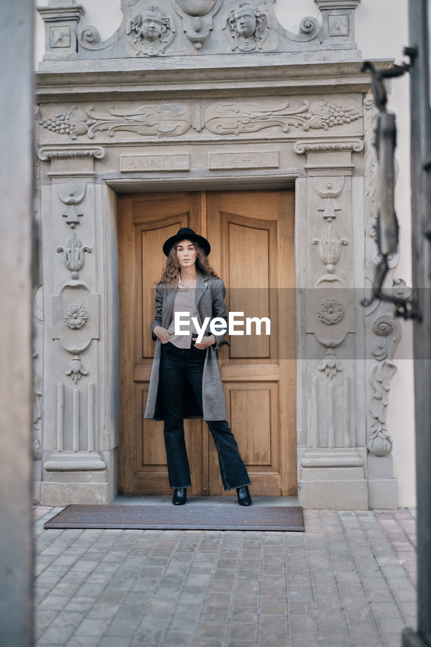 Portrait of woman standing at entrance